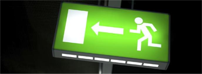 Emergency exit sign lit in the dark